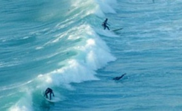surfing at Mawgan Porth Beach